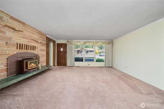 2815 NE Wyoming St, Bremerton, WA 98310 - unfurnished living room with carpet, a brick fireplace, and crown molding