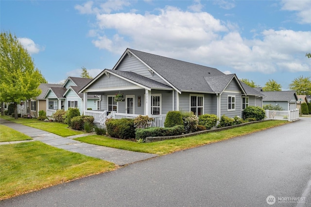2200 Goldenrod St, Ferndale, WA 98248 - view of front of property featuring a porch, a front lawn, a shingled roof, and a residential view