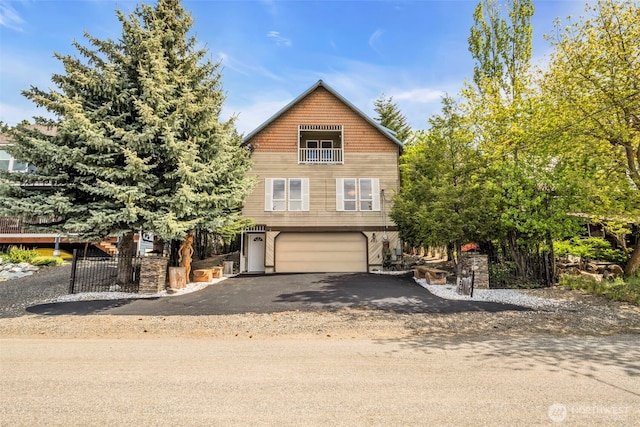 303 N B St, Roslyn, WA 98941 - view of front of property featuring a garage, asphalt driveway, and a balcony