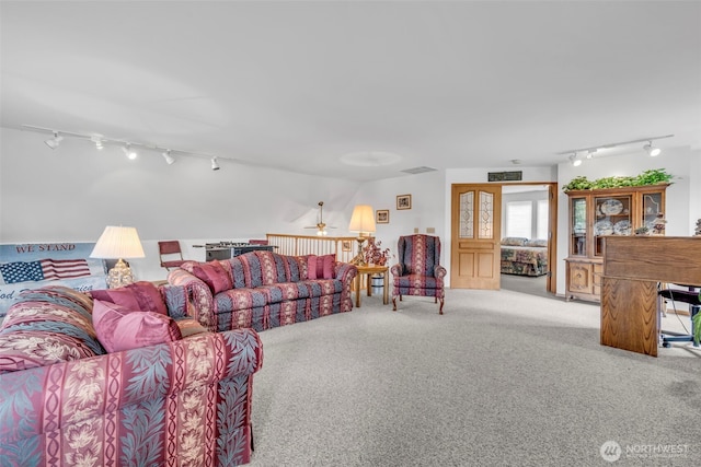 303 N B St, Roslyn, WA 98941 - living room featuring track lighting, light colored carpet, and a ceiling fan
