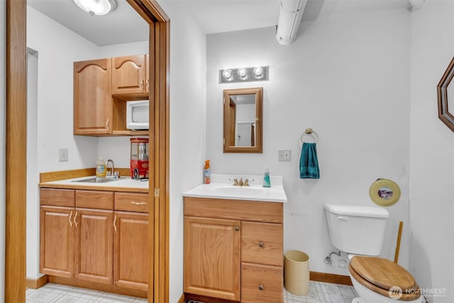 303 N B St, Roslyn, WA 98941 - bathroom featuring toilet, vanity, and baseboards