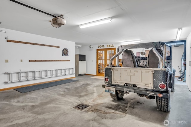 303 N B St, Roslyn, WA 98941 - garage featuring a garage door opener and refrigerator