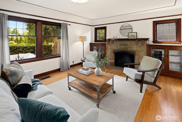 116 E Edgar St, Seattle, WA 98102 - living room with a fireplace with raised hearth, baseboards, and wood finished floors