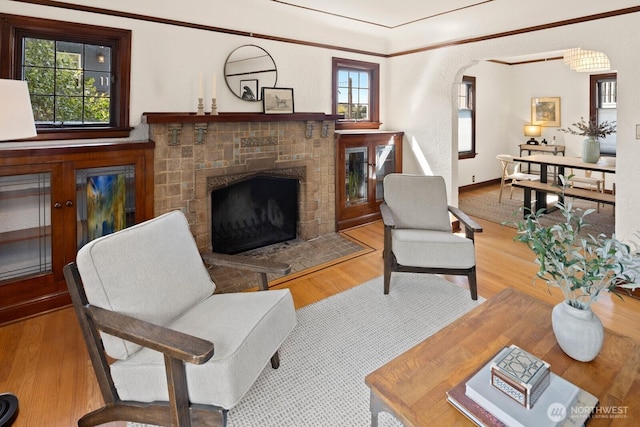 116 E Edgar St, Seattle, WA 98102 - living area featuring a fireplace, plenty of natural light, wood finished floors, and arched walkways