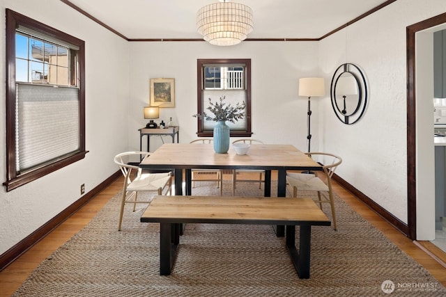 116 E Edgar St, Seattle, WA 98102 - dining room with crown molding, light wood-style flooring, and baseboards