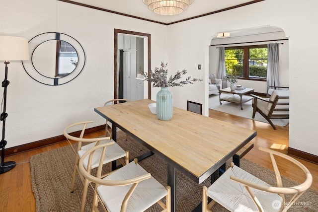 116 E Edgar St, Seattle, WA 98102 - dining space featuring light wood-type flooring, baseboards, and arched walkways