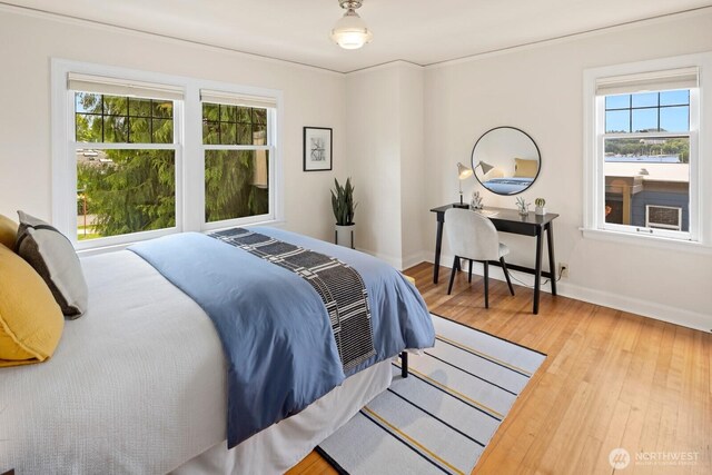 116 E Edgar St, Seattle, WA 98102 - bedroom featuring wood finished floors, multiple windows, and baseboards