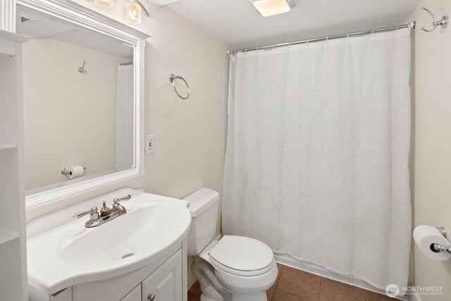 116 E Edgar St, Seattle, WA 98102 - bathroom with vanity, toilet, tile patterned floors, and curtained shower