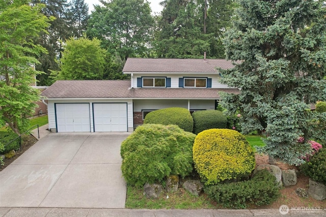 5003 120th Ave SE, Bellevue, WA 98006 - view of front of home with an attached garage, concrete driveway, and roof with shingles