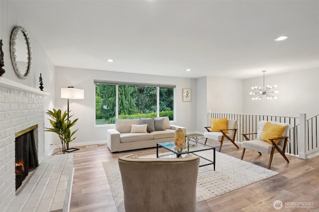 5003 120th Ave SE, Bellevue, WA 98006 - living room featuring light wood-style flooring, a fireplace, baseboards, a chandelier, and recessed lighting