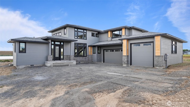 6988 Stonecrest Rd NE, Moses Lake, WA 98837 - prairie-style house with driveway, stone siding, and a garage