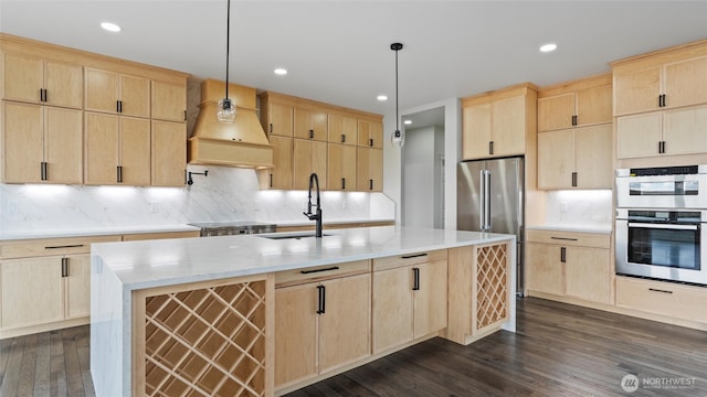 6988 Stonecrest Rd NE, Moses Lake, WA 98837 - kitchen featuring light brown cabinetry, custom range hood, appliances with stainless steel finishes, dark wood-style floors, and recessed lighting
