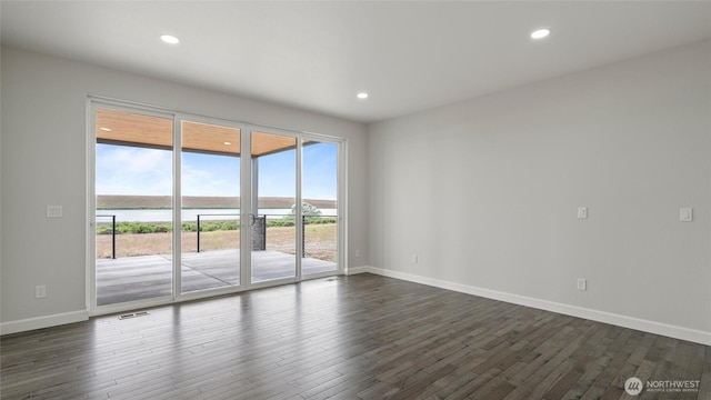6988 Stonecrest Rd NE, Moses Lake, WA 98837 - spare room with dark wood-style flooring, a water view, baseboards, and recessed lighting