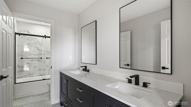 6988 Stonecrest Rd NE, Moses Lake, WA 98837 - full bathroom with bath / shower combo with glass door, double vanity, and toilet