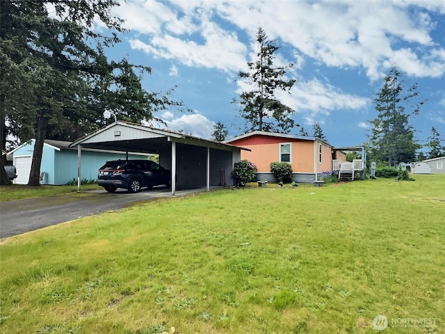 8304 192nd Street Ct E Unit 24, Spanaway, WA 98387 - view of front of property with a front lawn, asphalt driveway, and an attached carport