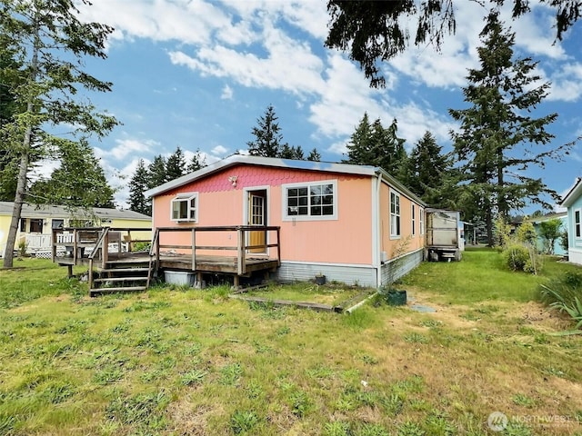8304 192nd Street Ct E Unit 24, Spanaway, WA 98387 - back of house featuring a deck and a yard