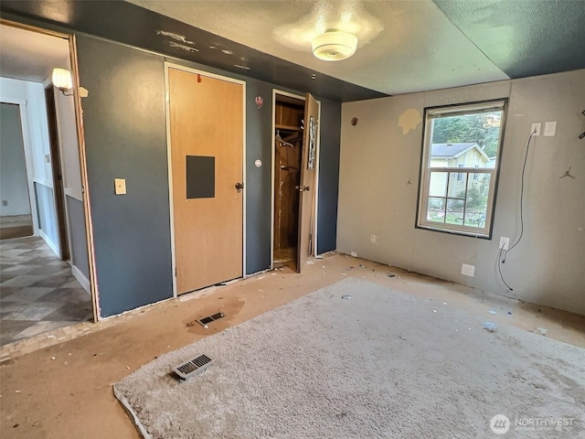 8304 192nd Street Ct E Unit 24, Spanaway, WA 98387 - unfurnished bedroom with two closets and a textured ceiling