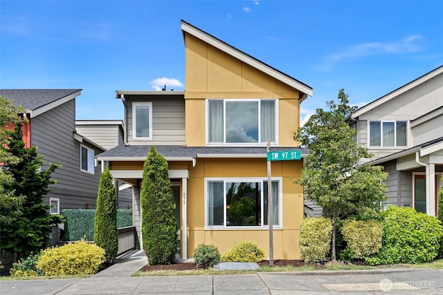 938 SW 97th St, Seattle, WA 98106 - view of front of house with stucco siding and roof with shingles
