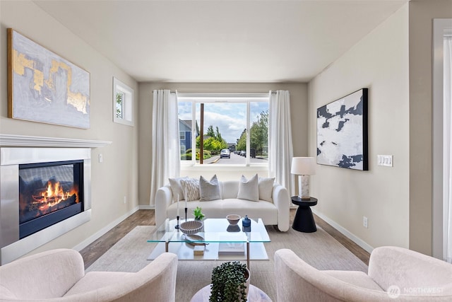 938 SW 97th St, Seattle, WA 98106 - living area featuring wood finished floors, baseboards, and a glass covered fireplace