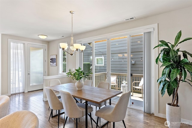 938 SW 97th St, Seattle, WA 98106 - dining area with light wood-style flooring and a chandelier