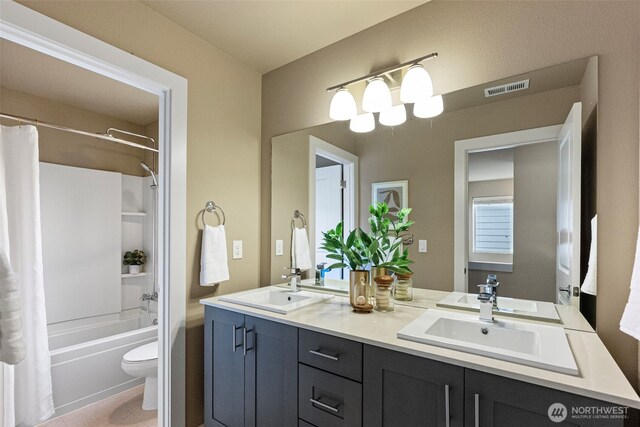 938 SW 97th St, Seattle, WA 98106 - bathroom with shower / tub combo, toilet, and double vanity