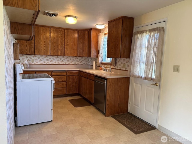 822 S Evergreen Dr, Moses Lake, WA 98837 - kitchen featuring white electric stove, dishwashing machine, light flooring, light countertops, and brown cabinetry