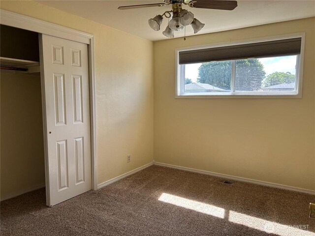 822 S Evergreen Dr, Moses Lake, WA 98837 - unfurnished bedroom with carpet, a closet, baseboards, and ceiling fan