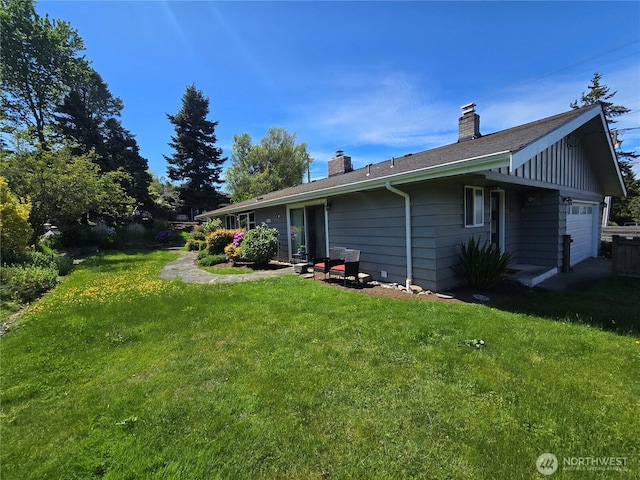 1012 9th Ave N, Edmonds, WA 98020 - rear view of house with an attached garage, a chimney, and a lawn