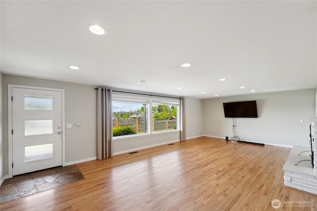 1012 9th Ave N, Edmonds, WA 98020 - unfurnished living room with light wood-type flooring, baseboards, and recessed lighting