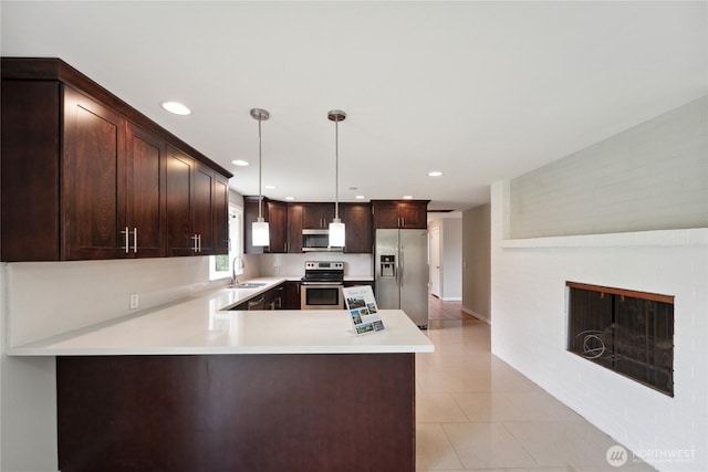 1012 9th Ave N, Edmonds, WA 98020 - kitchen with stainless steel appliances, dark brown cabinets, light countertops, light tile patterned flooring, and a sink