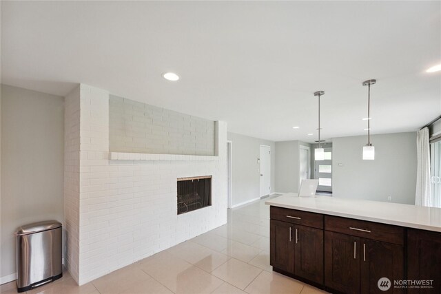 1012 9th Ave N, Edmonds, WA 98020 - kitchen with light countertops, dark brown cabinets, a fireplace, pendant lighting, and recessed lighting