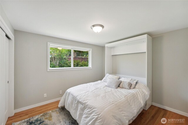 1012 9th Ave N, Edmonds, WA 98020 - bedroom with wood finished floors, baseboards, and a closet