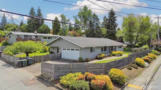 1012 9th Ave N, Edmonds, WA 98020 - view of front of house with a garage, concrete driveway, a chimney, and roof with shingles