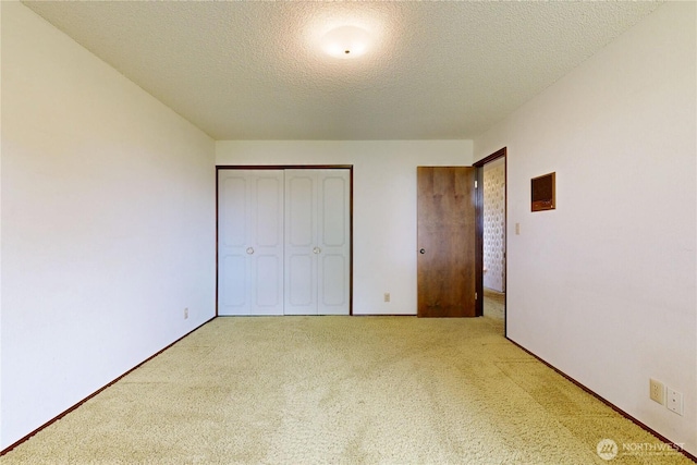 1220 Valley Vista Ave, Walla Walla, WA 99362 - unfurnished bedroom featuring carpet flooring, a closet, a textured ceiling, and baseboards