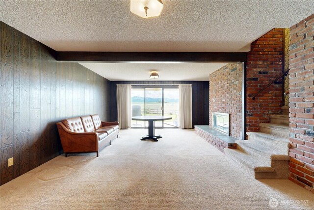 1220 Valley Vista Ave, Walla Walla, WA 99362 - carpeted living area with wood walls, a textured ceiling, a fireplace, and beamed ceiling