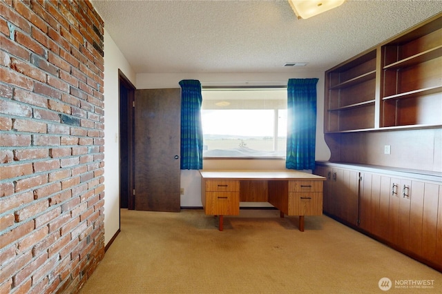 1220 Valley Vista Ave, Walla Walla, WA 99362 - unfurnished office with light colored carpet, a textured ceiling, and brick wall