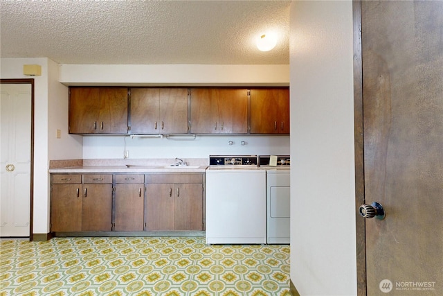1220 Valley Vista Ave, Walla Walla, WA 99362 - kitchen featuring washer and clothes dryer, light countertops, a textured ceiling, light flooring, and a sink