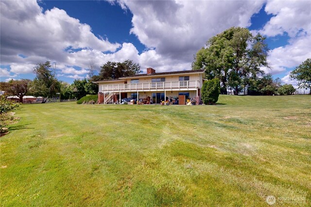 1220 Valley Vista Ave, Walla Walla, WA 99362 - back of property with stairway, a chimney, a yard, and a deck