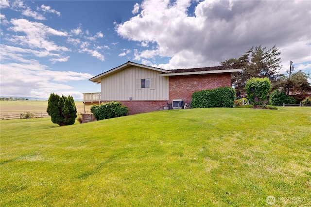 1220 Valley Vista Ave, Walla Walla, WA 99362 - view of property exterior featuring board and batten siding, brick siding, a lawn, and central air condition unit