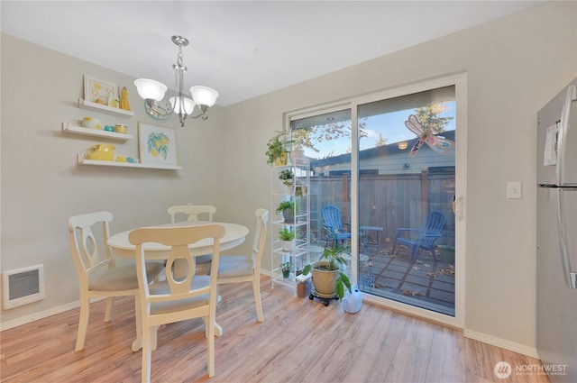 20620 76th Ave W Unit A, Edmonds, WA 98026 - dining space with a chandelier, wood finished floors, and baseboards