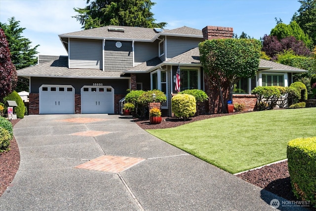 16605 71st Pl W, Lynnwood, WA 98037 - view of front facade featuring a front yard, a garage, concrete driveway, brick siding, and a shingled roof