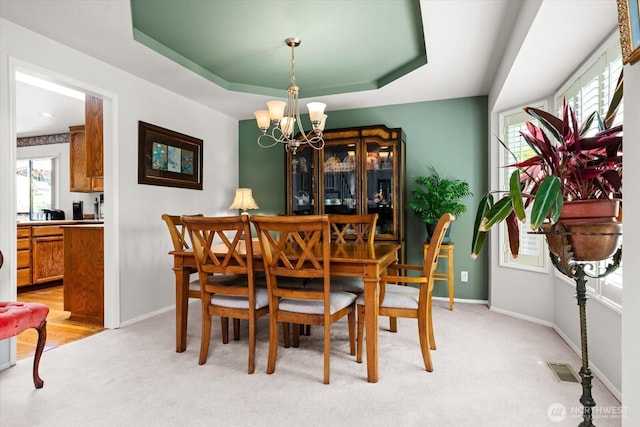 16605 71st Pl W, Lynnwood, WA 98037 - dining room with a chandelier, light carpet, a raised ceiling, and baseboards