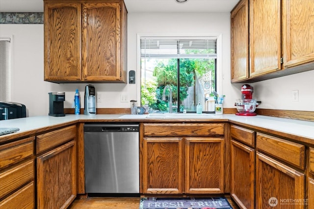16605 71st Pl W, Lynnwood, WA 98037 - kitchen featuring stainless steel dishwasher, a sink, light countertops, and brown cabinetry