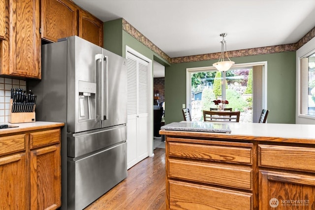 16605 71st Pl W, Lynnwood, WA 98037 - kitchen with stainless steel fridge with ice dispenser, wood finished floors, plenty of natural light, and light countertops
