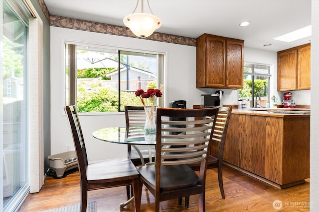 16605 71st Pl W, Lynnwood, WA 98037 - dining space featuring light wood-type flooring, healthy amount of natural light, a skylight, and recessed lighting