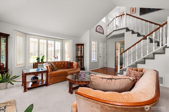 16605 71st Pl W, Lynnwood, WA 98037 - carpeted living room with stairway, high vaulted ceiling, and baseboards