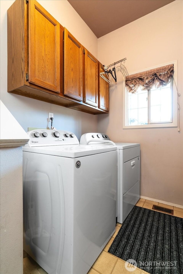 16605 71st Pl W, Lynnwood, WA 98037 - laundry room featuring cabinet space, independent washer and dryer, and light tile patterned flooring