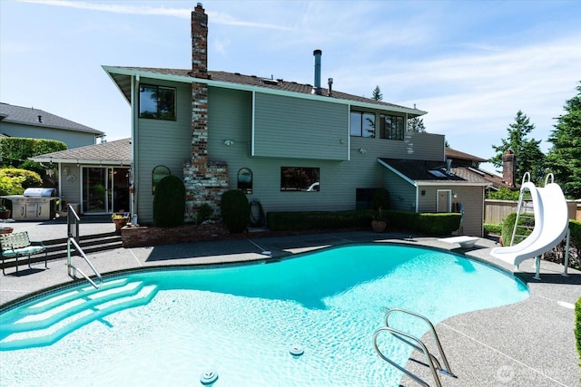 16605 71st Pl W, Lynnwood, WA 98037 - outdoor pool featuring a water slide, a patio area, and a diving board