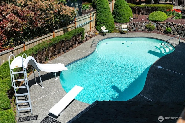 16605 71st Pl W, Lynnwood, WA 98037 - view of swimming pool with a water slide, a diving board, and a fenced backyard
