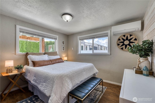 421 Lakeview Dr, Orondo, WA 98843 - bedroom featuring a wall mounted AC, wood finished floors, baseboards, a textured ceiling, and a textured wall